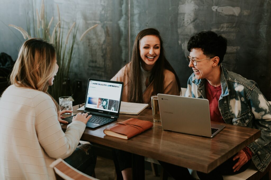 Co-workers in a casual office laughing - Photo by Brooke Cagle on Unsplash
