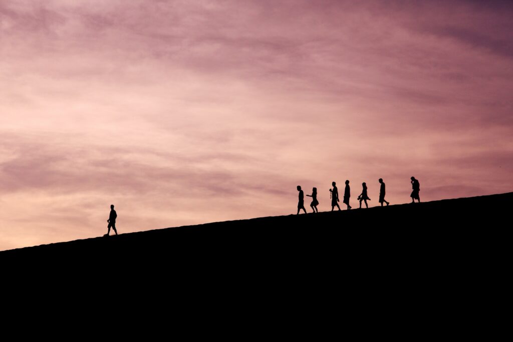 silhouette of people on hill - Photo by Jehyun Sung on Unsplash
