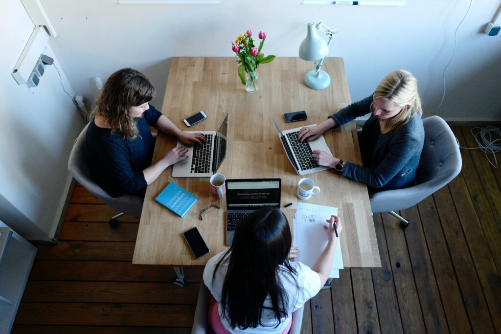 three women sitting around table using laptops

Photo by CoWomen on Unsplash